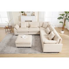 a living room with a sectional couch and ottoman