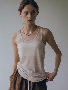 This is vanone atelier’s lightweight sheer fabric with just the right amount of translucency to avoid feeling overwhelming. Its soft and stretchy texture drapes nicely along the body, providing a comfortable and effortless fit. You can pair it as a set with a T-shirt made from the same fabric. - Perfect for everyday wear- Can be styled with various styles of bottoms for different looks- A versatile item that pairs well with any outfit Sheer Stretch Tank Top, Sheer Sleeveless Beige Top, Sleeveless Sheer Beige Tops, Beige Sheer Sleeveless Top, Sheer Tank Top For Layering, Sheer Tank Top For Summer Layering, Sheer Tank Top For Layering In Spring, Spring Sheer Tank Top For Layering, Effortless Tank Top For Summer Layering