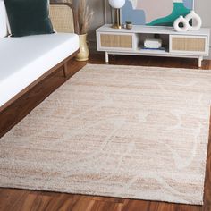 a living room with a white couch and rug on top of the wooden flooring