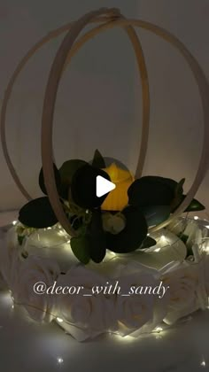 a wedding cake decorated with flowers and lights