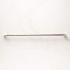 a white wall with a metal bar on it