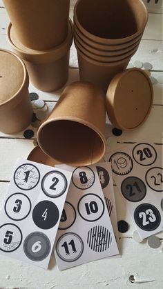 some brown cups and numbers are on the table