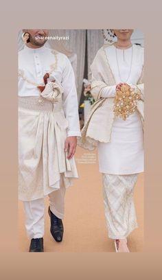 two people dressed in white are walking together