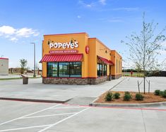 a pope's restaurant in the middle of a parking lot with trees and bushes