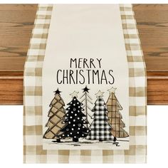 a kitchen towel hanging on the side of a wooden door with christmas trees in it