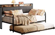 a day bed with a pull out trundle and pillows on the bottom shelf