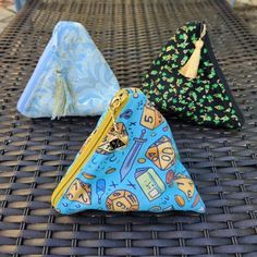 three small purses sitting on top of a table