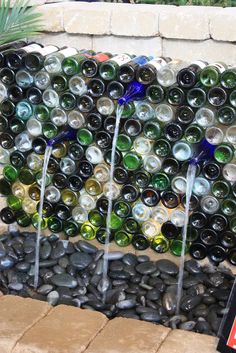 there are many different colored glass bottles on the table and in front of each other