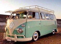 an old vw bus is parked in the dirt