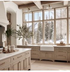 a kitchen filled with lots of counter top space next to a window covered in snow