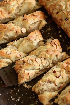 sliced almond scones sitting on top of a baking sheet