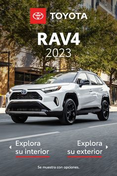 a white toyota rav4 driving down a street