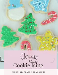 some decorated cookies on a plate with the words glosy cookie icing above it