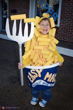 a little boy in a bucket that has been made to look like he is holding a pitchfork