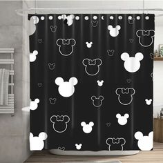 a shower curtain with mickey mouse heads on it