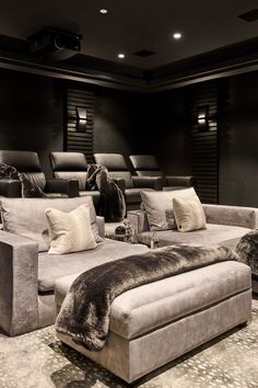 a living room filled with lots of furniture and pillows on top of a carpeted floor