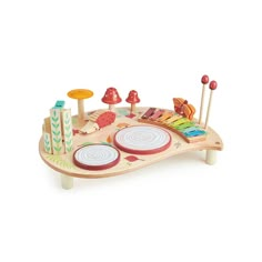 a wooden play table with musical instruments on it's sides and an assortment of colorful objects in the background