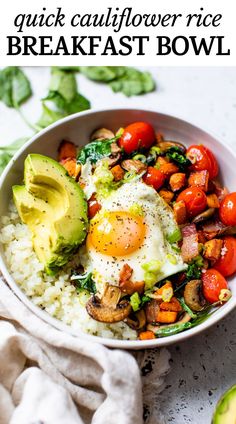 a white bowl filled with rice, vegetables and an avocado in the middle