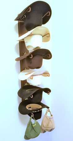 Product DescriptionYou will Love this Cowboy Hat Holder.  Easily holds up to Six Cowboy Hats. Designed to Keep Your Hats Shape.  It is decorative and functional and you will love that it looks great on any wall. The decorative stars make this hat rack great Western Wall Art as well. Some Assembly Required.  Proudly Made in The USA!  Item is Hand Finished and Powder Coated.  Wall Mounting Hardware is included.Please note product may vary slightly from photos. NEW Improved U shape bracket for easi Welded Crafts, Cowboy Hat Holder, Hat Holders, Wall Hat Racks, Cowboy Hat Rack, Cowboy Hat Design, Wall Hats, Hat Racks, Horseshoe Decor