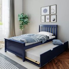 a bedroom with a blue bed frame and white pillows on the pillowcases next to it