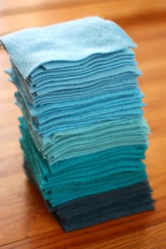 a stack of folded towels sitting on top of a wooden table