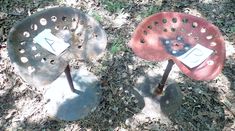 two metal chairs sitting on top of a grass covered field