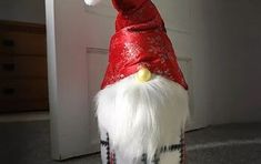 a red and white gnome hat sitting on top of a door