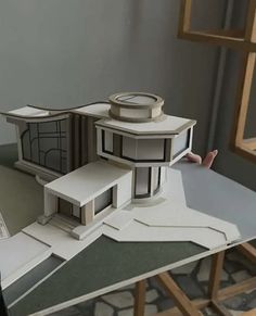 a paper model of a house sitting on top of a table