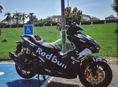 a black motorcycle parked next to a street sign