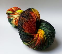 two skeins of multicolored yarn on a white surface