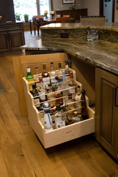 an open drawer in the middle of a kitchen with spices and condiments on it