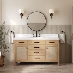 a bathroom with two sinks and a round mirror above the sink, in front of a bathtub