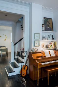 a living room filled with furniture and a piano