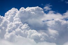 the sky is filled with white clouds and blue skies are visible in the foreground