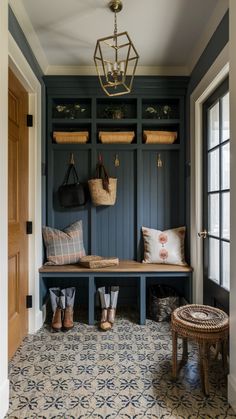 an entryway with blue painted walls and wooden benches, baskets on the back wall