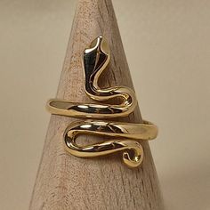 Simple, elegant handmade ring in shape of snake The ring is made of 18 carat solid yellow gold It's an adjustable ring from size U.S 6.1/2 to 9.00 Snake was the symbol of health in ancient Greece The ring is made in Greece in our workshop in Athens An elegant classic piece of jewelry SHIPPINGINFORMATION FREE SHIPPING VIA DHL EXPRESS Please fill an active phone number It is required by the courier company DELIVERY INFORMATION 1-3 Working days To EUROPE 3-5 Working days To U.S.A, and CANADA 5-8 Wo Unique Gold Snake Ring For Formal Events, Unique Gold Snake Ring For Formal Occasions, Elegant Gold Snake Ring In Brass, Elegant Gold Brass Snake Ring, Adjustable Gold Snake Ring, Yellow Gold Snake-shaped 14k Gold Rings, Unique Yellow Gold Snake Ring, Snake-shaped Yellow Gold Wedding Ring, Elegant 14k Gold Snake-shaped Ring