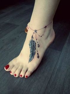 a woman's foot with a feather and beads tattoo on the bottom of it