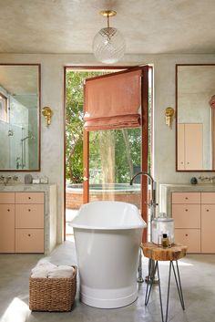 a large white bath tub sitting inside of a bathroom