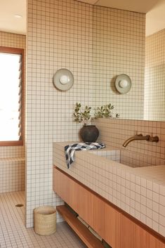 a bathroom with tiled walls and two sinks