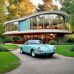 a blue car is parked in front of a circular house with glass walls and large windows