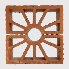 an object made out of bricks with a circular hole in the center and small squares on each side