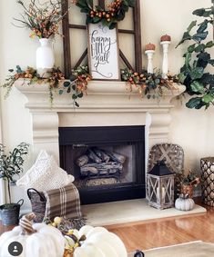 a fireplace decorated for fall with pumpkins, greenery and other decorations on the mantle