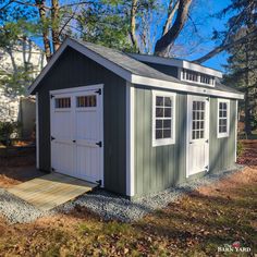 a small shed sitting in the middle of a yard