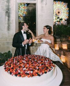 a newly married couple feeding each other cake