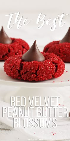 red velvet peanut butter blossoms on a white plate with the words we best written above them