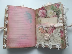 an open book with lace and flowers on it