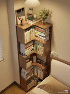 a book shelf filled with books next to a bed in a small room on top of a hard wood floor