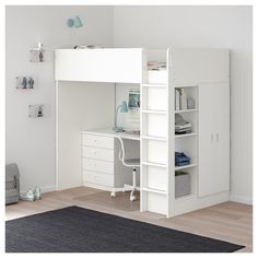 a pink and white loft bed with desk underneath it in a child's bedroom