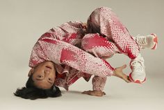 a man is upside down on the ground with his feet in the air while wearing red and white pajamas