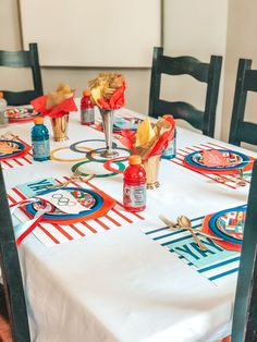 the table is set with colorful plates and napkins